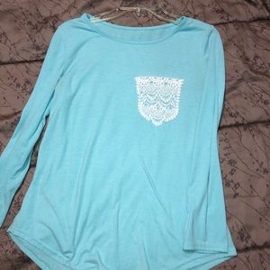 Long sleeve blue shirt with white pouch